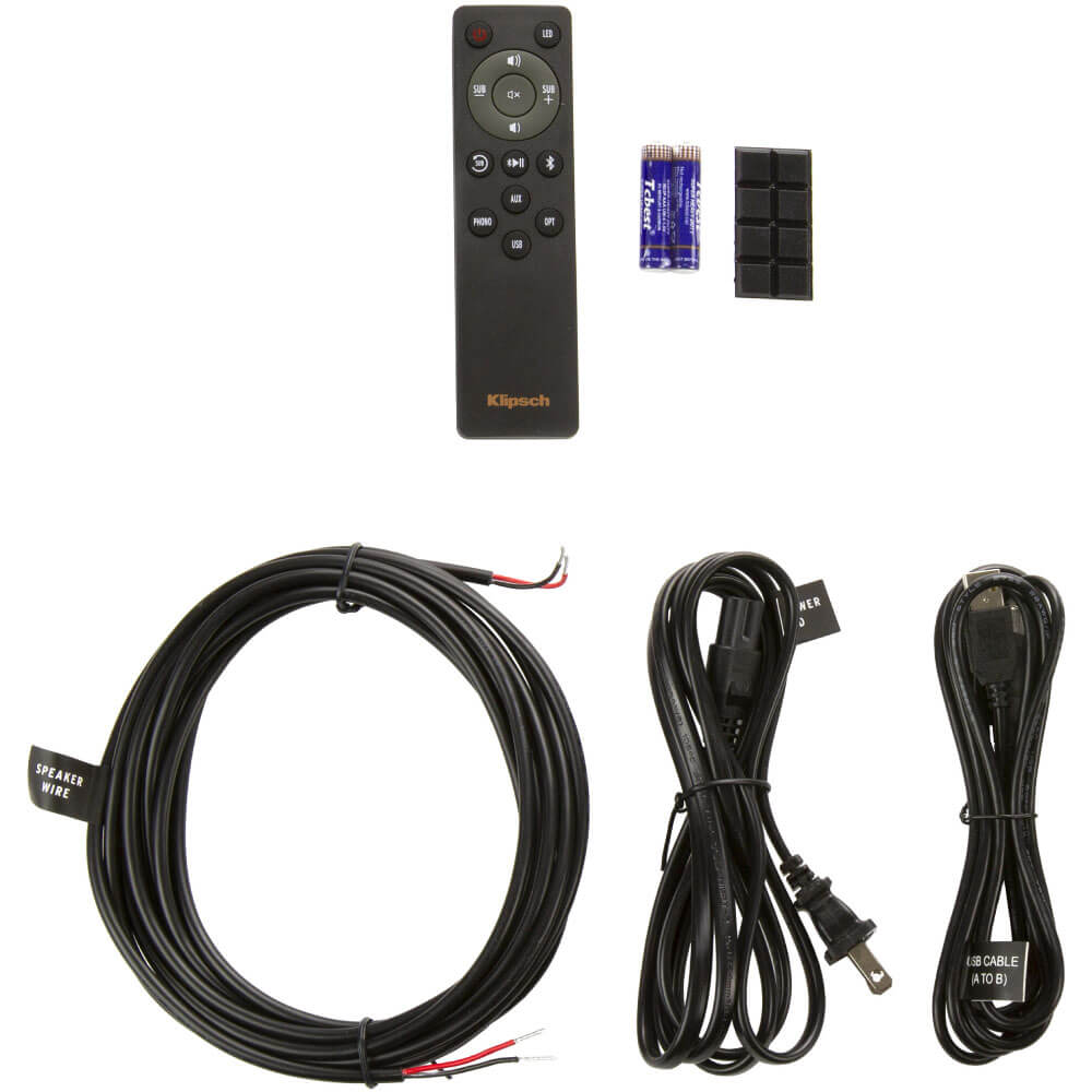 Klipsch R-41Pm Powered Speakers Klipsch wireless speaker system kit with remote, two aa batteries, speaker wire, usb cable, and power cords.