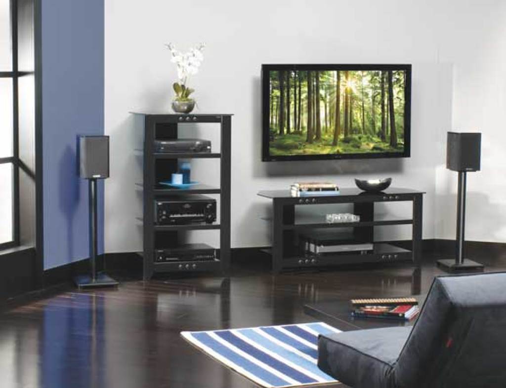 Sanus Nf30 30&Quot; Natural Series Wood Pillar Bookshelf Speaker Stands Contemporary living room with a flat-screen tv on a black media stand and dual floor-standing speakers.