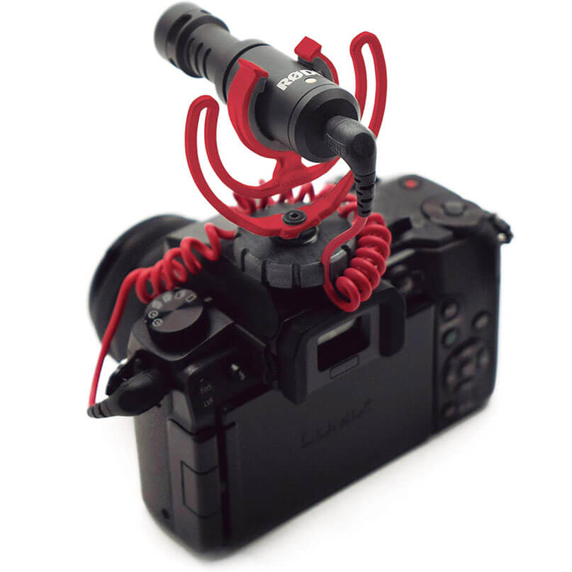 Rode Videomicro Panasonic lumix digital camera with a rode external microphone mounted on a red shock mount.
