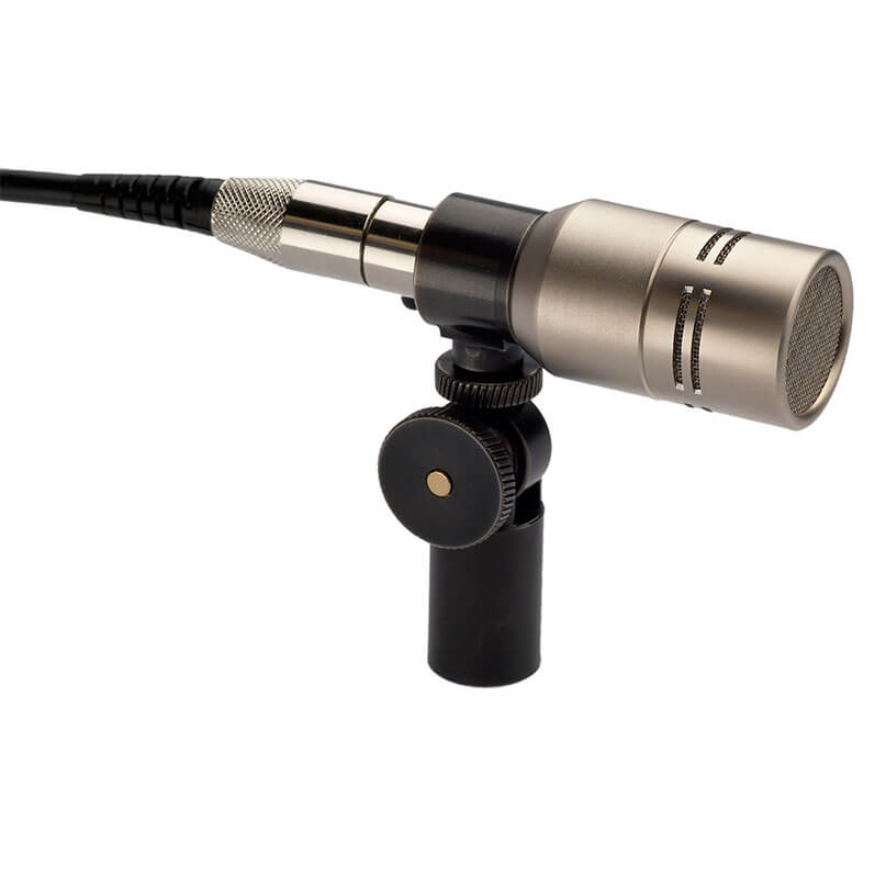 Rode Nt6 Silver condenser microphone with xlr cable mounted on an adjustable stand.