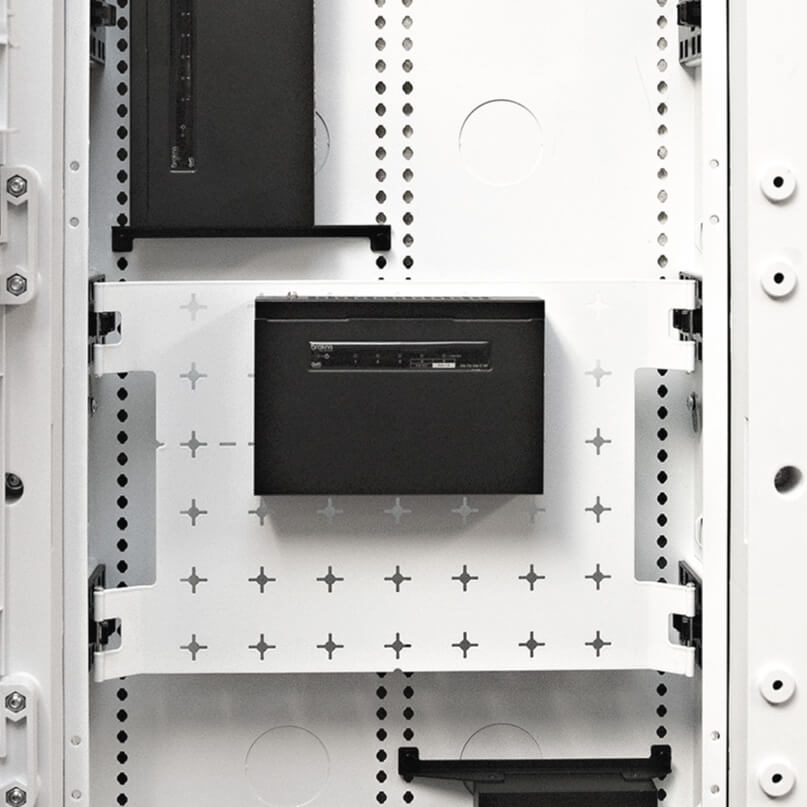 Araknis Networks 110 Series Unmanaged+ Gigabit 5 Port Compact Switch Powered By Poe White rack cabinet interior with black front panel module mounted on perforated rails.