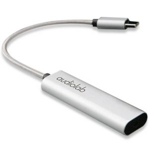 A silver Audiolab P-DAC Headphone Amplifier-DAC USB-C to 3.5mm adapter with a flexible cable and Audiolab branding on the side.
