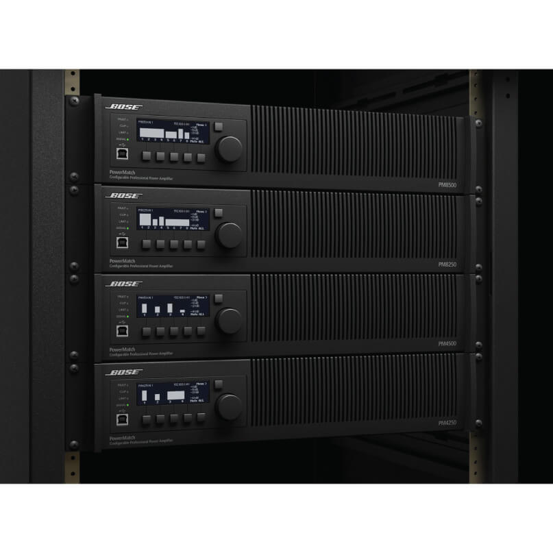 Bose Powermatch Pm8500N Professional Power Amplifier Four bose powermatch pm4500 professional rack-mount power amplifiers with display panel and control knobs mounted in an equipment rack.