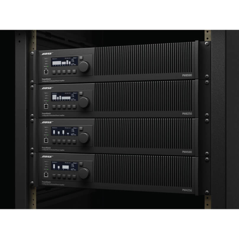 Bose Powermatch Pm8500N Professional Power Amplifier Bose powermatch rack-mount amplifiers—four units with blue lcd screens, control knobs, and vertical vented fronts in a server rack.