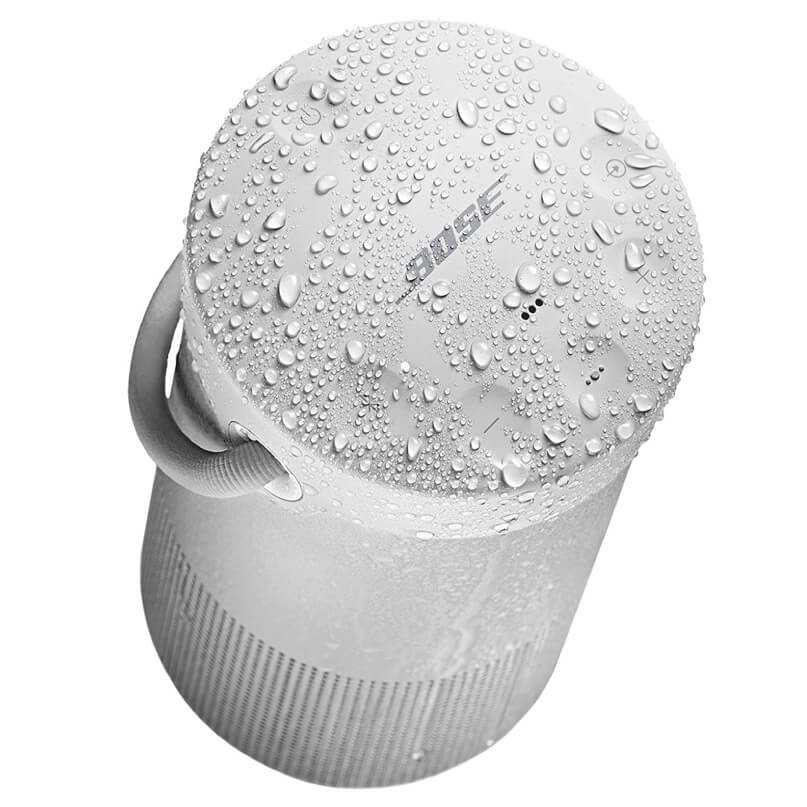 Bose Soundlink Revolve+ Bluetooth Speaker Bose soundlink revolve+ cylindrical portable bluetooth speaker with built-in carrying strap, covered in water droplets.
