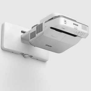 An Epson EB-685W Ultra-Short Throw Projector in white is mounted on a bracket against a plain light-colored background.