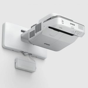 Epson white projector mounted on a wall bracket with power box.