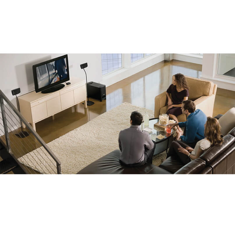 Bose Ufs-20 Series Ii Universal Floorstands-Black/White Group of people watching a flat-screen tv on a beige media console in a modern living room.