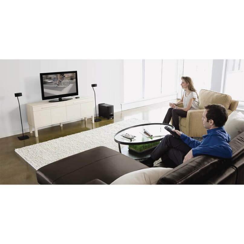 Bose Ufs-20 Series Ii Universal Floorstands-Black/White Living room with a flat-screen tv on a white media console, floor-standing speakers, and a round glass coffee table.