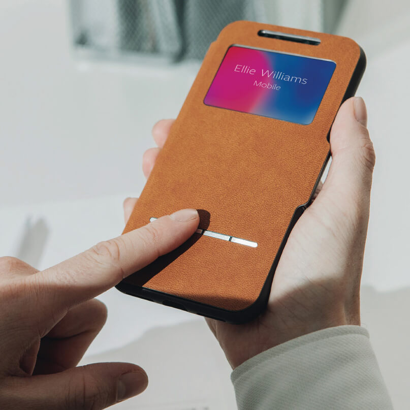 Moshi Sensecover For Iphone X/Xs - Black Smartphone in a brown leather folio case with a gradient name card reading ellie williams mobile.