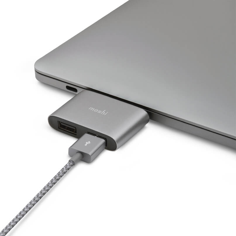 Moshi Usb-C To Dual Usb-A Adapter Moshi usb-c to hdmi adapter connected to a silver laptop, with braided cable and aluminum housing