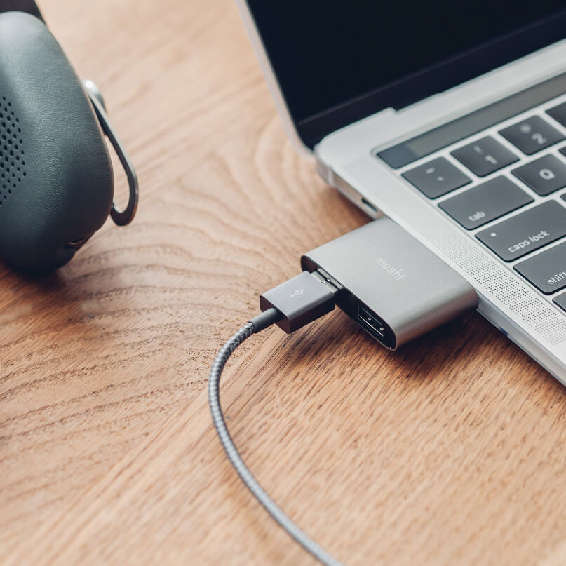 Moshi Usb-C To Dual Usb-A Adapter Moshi usb-c adapter dongle connected to a macbook with a braided gray cable.