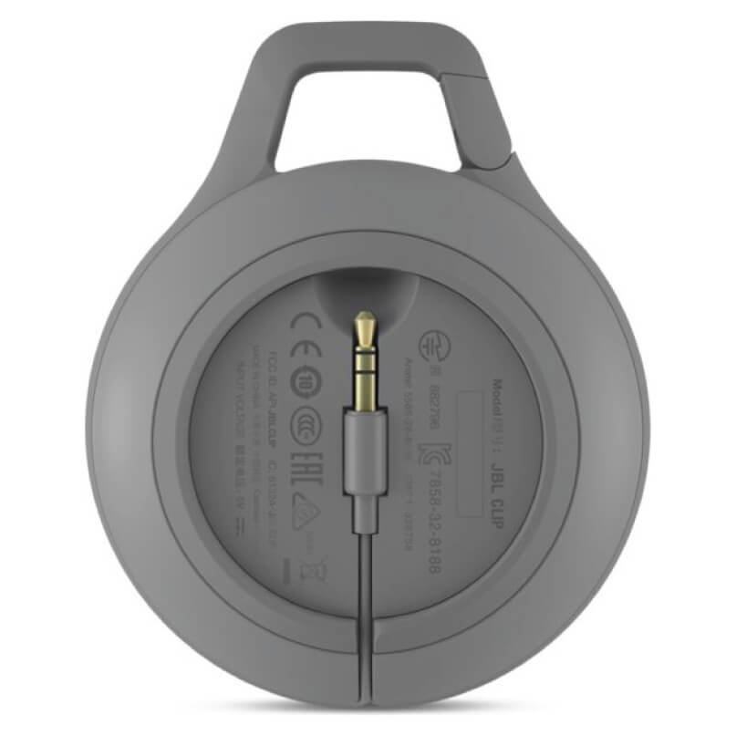 Jbl Clip+ Ipod And Iphone Speaker System Gray circular wireless headphones with detachable 3. 5mm audio cable and integrated top handle, front view.