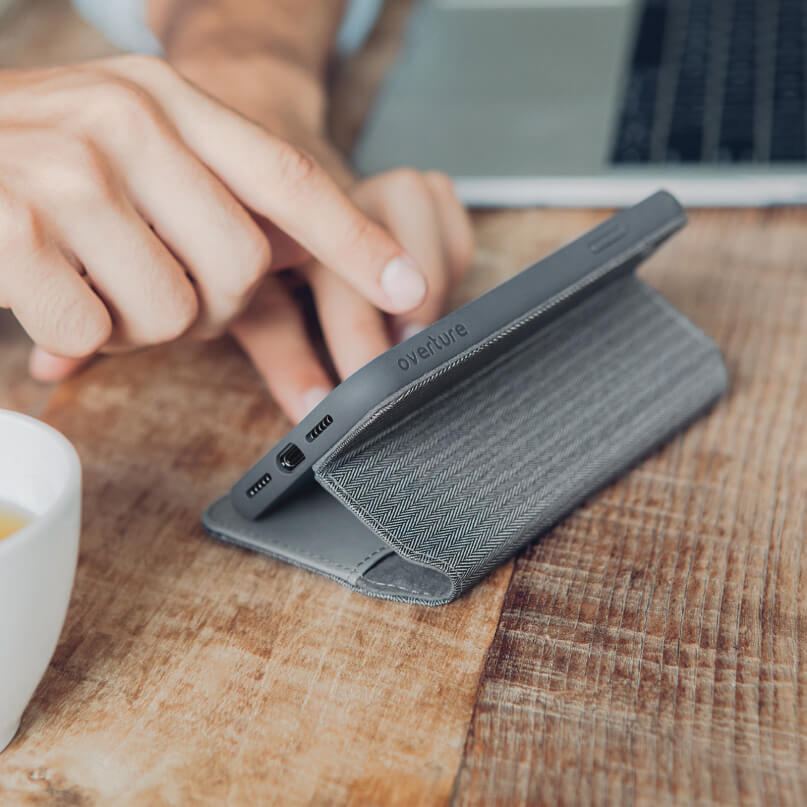 Moshi Overture For Iphone Xr Gray overture phone case with foldable stand and textured inner cover on a wooden table