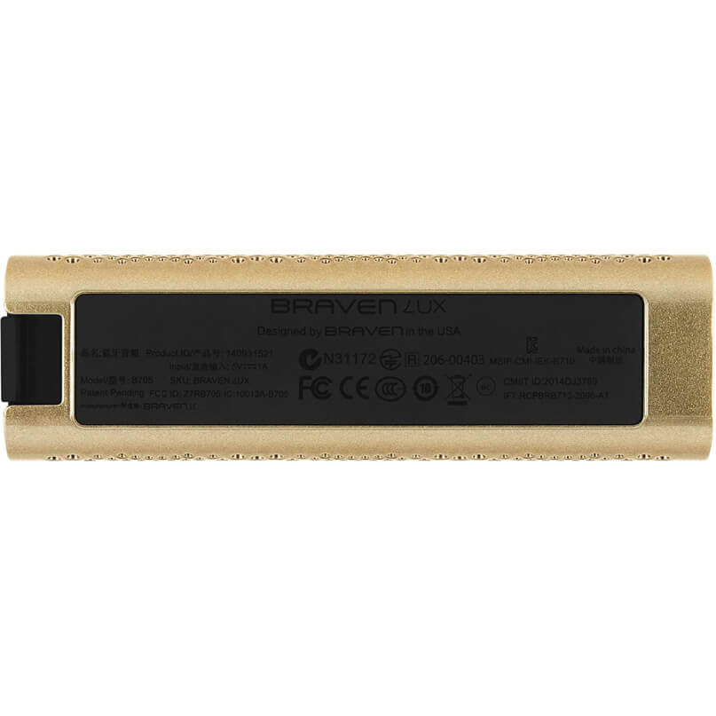 Braven Lux Speaker Braven lux gold portable bluetooth speaker with black center label and regulatory icons.