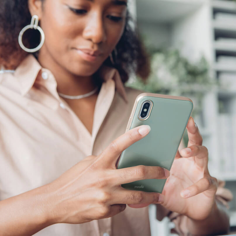 Moshi Iglaze For Iphone Xs Max Person holding a mint green smartphone with a slim case and dual rear cameras.