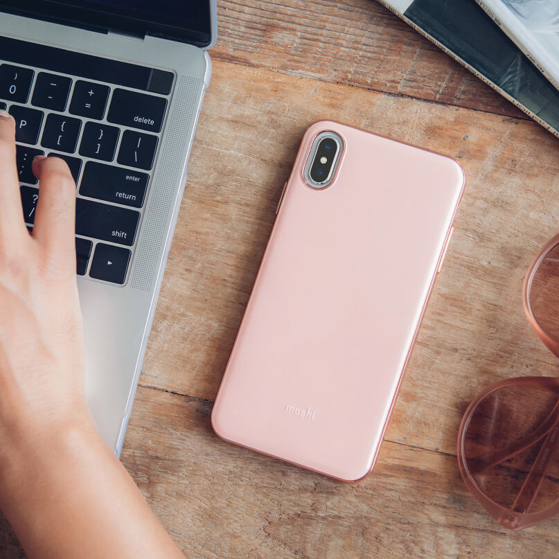 Moshi Iglaze For Iphone Xs Max Apple iphone in a pink moshi case with a dual-camera rear, on a wooden desk beside a laptop.