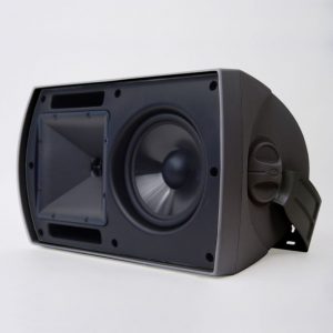 Black loudspeaker enclosure featuring a large woofer and integrated side mounting bracket.