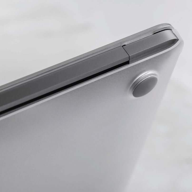 Moshi Iglaze For Macbook Air 13 (Thunderbolt 3/Usb-C) Close-up of a silver laptop with a slim hinge and a circular rubber foot.