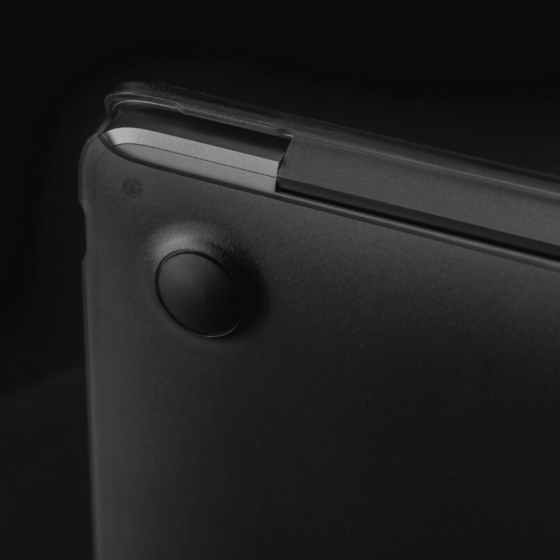 Moshi Iglaze For Macbook Air 13 (Thunderbolt 3/Usb-C) Close-up of a black laptop bottom with a circular rubber foot near the hinge.