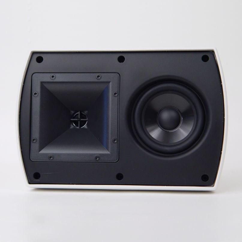 White curved speaker cabinet with a black front panel, square horn on the left and round woofer on the right.