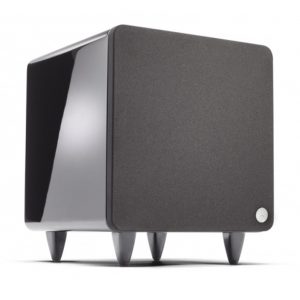 Compact black subwoofer with fabric front grille, glossy side panel, four feet, and a small white control knob.