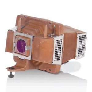 Brown vintage film projector lamp housing with purple circular lens, metal vent panels, and adjustable base