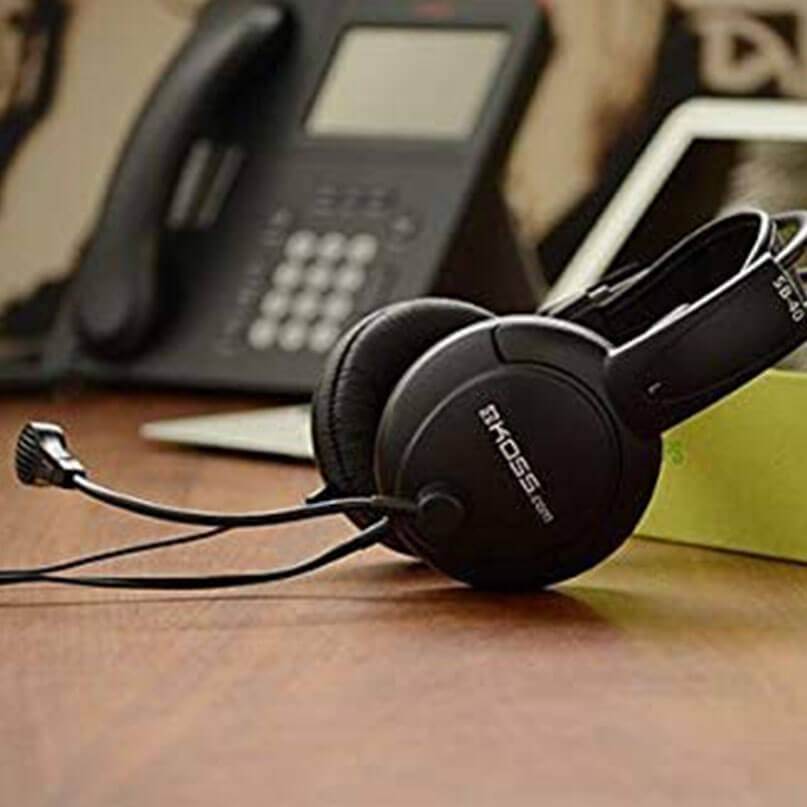 Koss Sb42 Headsets Epos wired over-ear headset with boom microphone on a wooden desk.