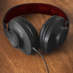 Bose over-ear wired headphones with black cushioned cups and red headband interior.