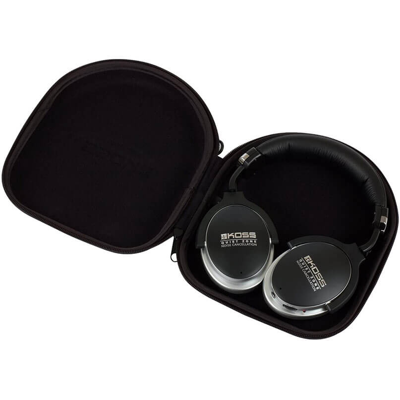 Koss Qz900 Noise Cancelling Headphoness Koss over-ear headphones with noise cancellation in black and silver inside a black hard-shell case.