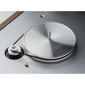 Interdyn Brushed metal turntable with central spindle and belt-driven pulley on a metal work surface.