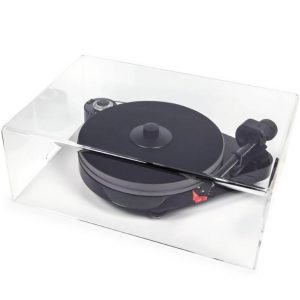 Interdyn Clear acrylic display case housing a black turntable with tonearm and red cartridge.