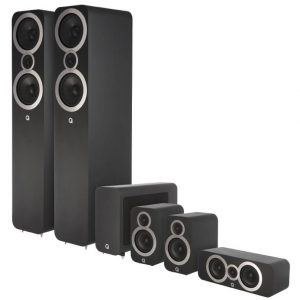 Q Acoustics black 5.1 home theater system with two floorstanding speakers, a center speaker, and multiple satellite speakers.