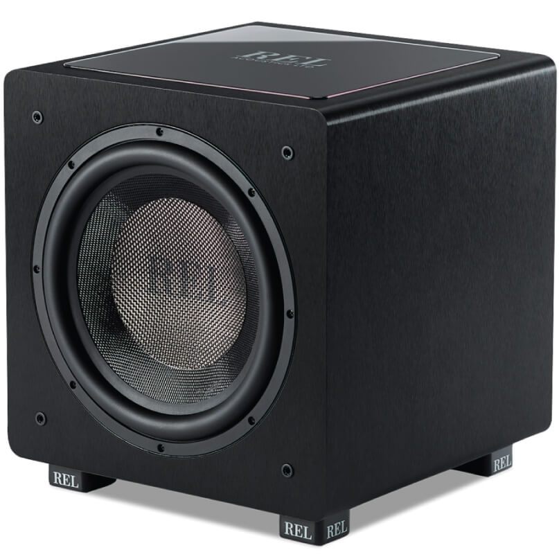 Rel Ht/1205 Rel subwoofer cube with black textured enclosure, front facing large driver with metal grille, rubber surround, and branded feet.