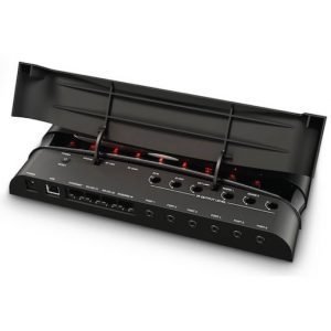 Black rack-mount multi-port audio interface with hinged lid, USB port, and multiple input/output jacks.