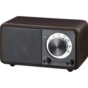 Brown vintage tabletop radio with a large circular tuning dial and left speaker grille.