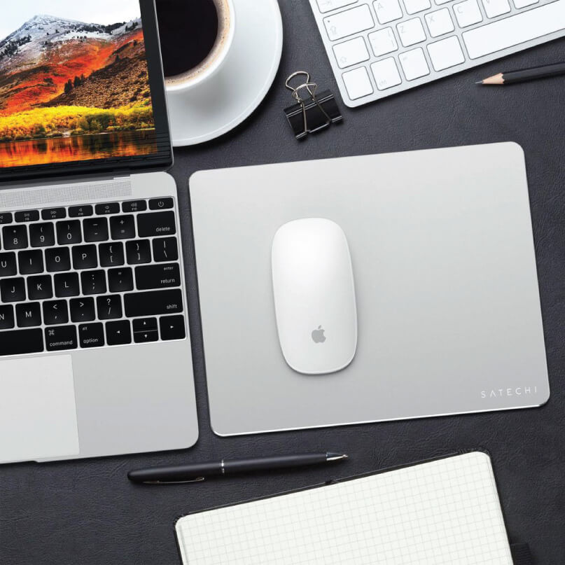 Satechi Aluminium Mouse Pad Apple macbook pro laptop with white magic mouse on a silver satechi aluminum desk mat