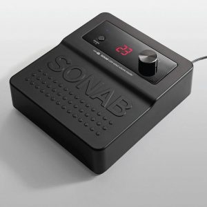 SONAB audio device with red digital display reading 23, large top knob, and embossed perforated speaker area.