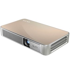 Lumi portable projector with gold top, front lens, metal badge, and side ventilation grill.
