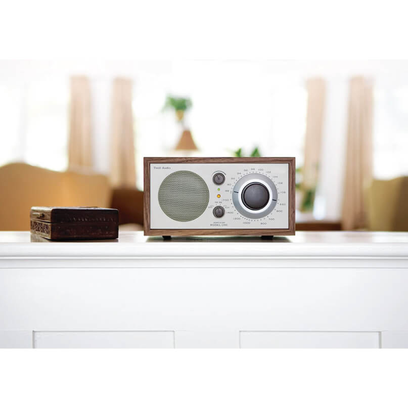 Tivoli Audio Model One Am/Fm Table Radio Vintage wood-cased tabletop radio with a large round dial and front speaker grille on a white shelf.