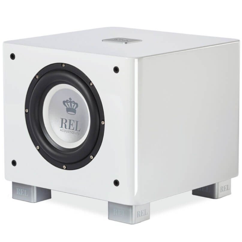 Rel Serie T/7X Rel acoustics white subwoofer with front-mounted circular driver, black bezel, silver rel crown dust cap, and four silver feet.