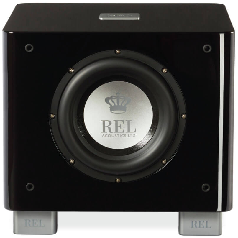 Rel Serie T/7X Rel acoustics subwoofer with glossy black cabinet, centered silver logo badge, and branded metal feet.