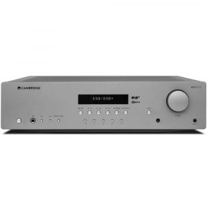 Cambridge Audio AXR100D stereo receiver with a DAB/DAB+ display, multiple buttons, and a large right-side volume knob.