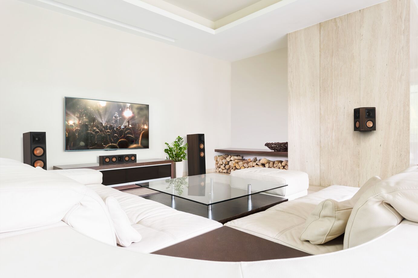 Klipsch Rp-6000F Ii Modern living room with wall-mounted flat-screen tv, white sectional sofa, glass coffee table, soundbar, and tall black floor speakers.