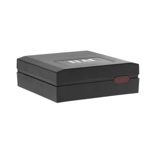 Black two-piece clamshell storage box with a top slot and a red oval latch on the front.