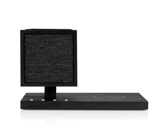 Tivoli Audio Revive Bluetooth Speaker With Wireless Charging Pad And Lamp Black desktop speaker with a square driver on a short pedestal mounted on a flat rectangular base.