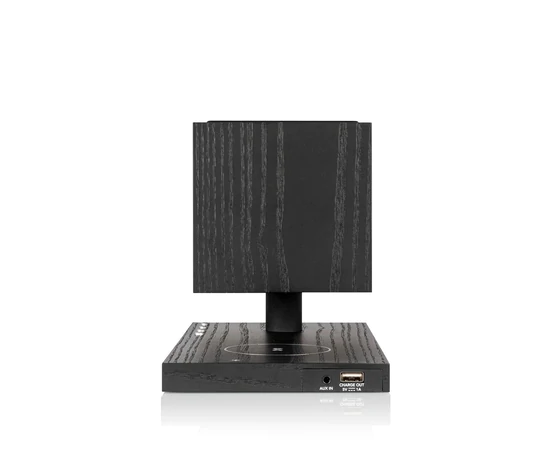 Tivoli Audio Revive Bluetooth Speaker With Wireless Charging Pad And Lamp Black wood grain desktop speaker system with a square cube satellite on a pedestal and usb port on base.