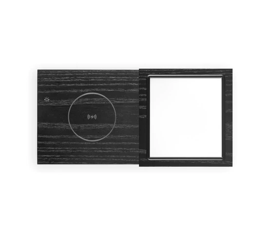 Tivoli Audio Revive Bluetooth Speaker With Wireless Charging Pad And Lamp Black woodgrain wall plate with circular wireless charging pad on left and square recessed frame on right.