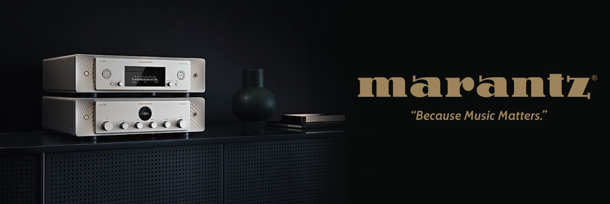Two stacked marantz stereo amplifiers on a dark cabinet beside vase and books, with marantz logo and because music matters.