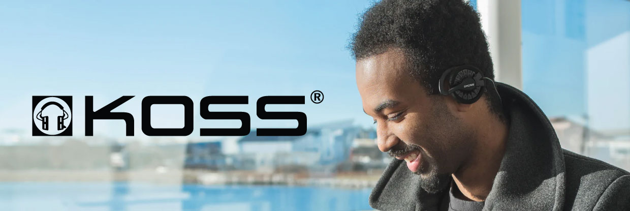 Man wearing koss over-ear headphones outdoors with a blurred urban background
